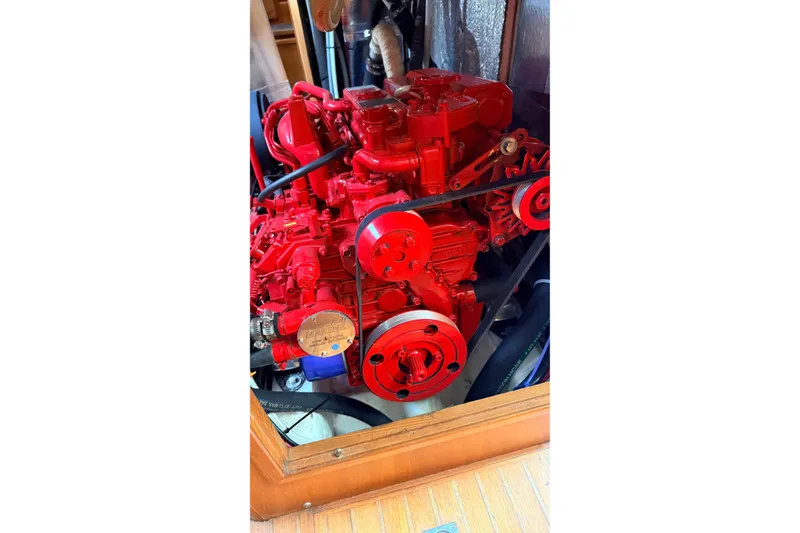Slide: The Image of Red engine of a 1983 Tanton 44 boat, showcasing intricate mechanical details. - 30