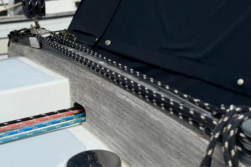 Slide: The Image of Close-up of 1983 Tanton 44 sailboat deck with colorful ropes and black cover. - 36