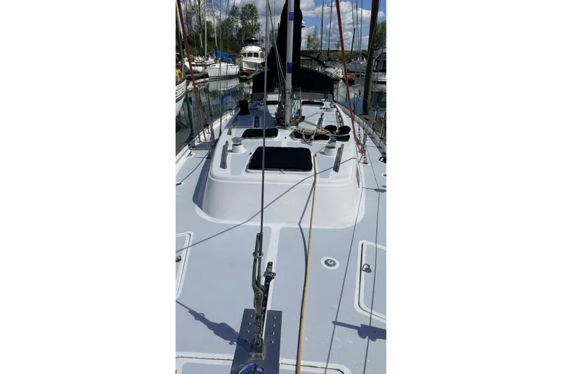 Slide: The Image of 1983 Tanton 44 sailboat deck view in marina, showcasing sleek design and rigging. - 41