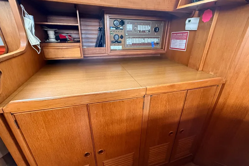 Slide: The Image of 1983 Tanton 44 yacht interior with wooden cabinetry and control panel. - 8