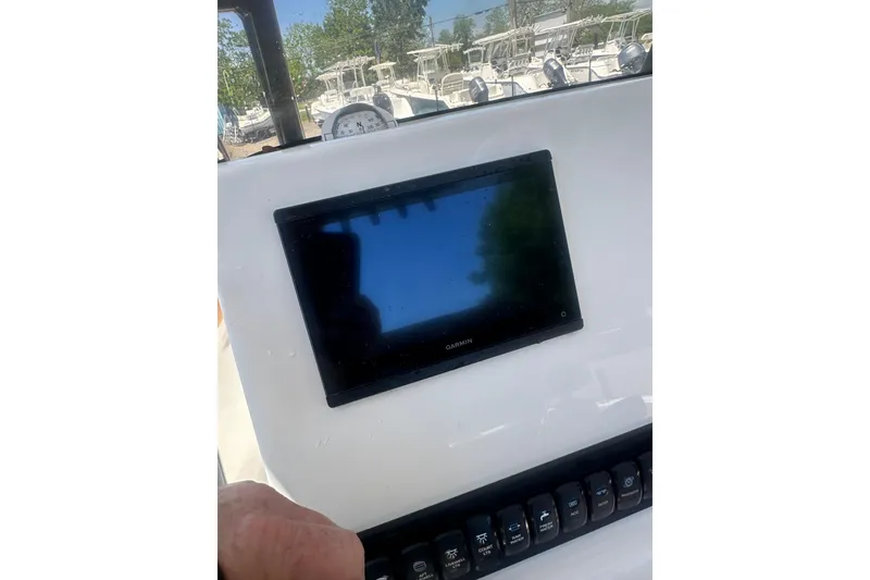 Slide: The Image of 2026 Key West 239 FS boat dashboard with Garmin display and control panel. - 12