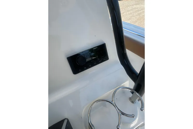 Slide: The Image of 2026 Key West 239 FS boat dashboard with stereo system and cup holders. - 14