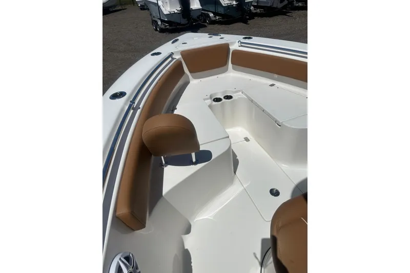Slide: The Image of 2026 Key West 239 FS boat interior with tan seating and cup holders. - 18
