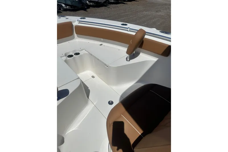 Slide: The Image of 2026 Key West 239 FS boat interior with tan seating and cup holders. - 19