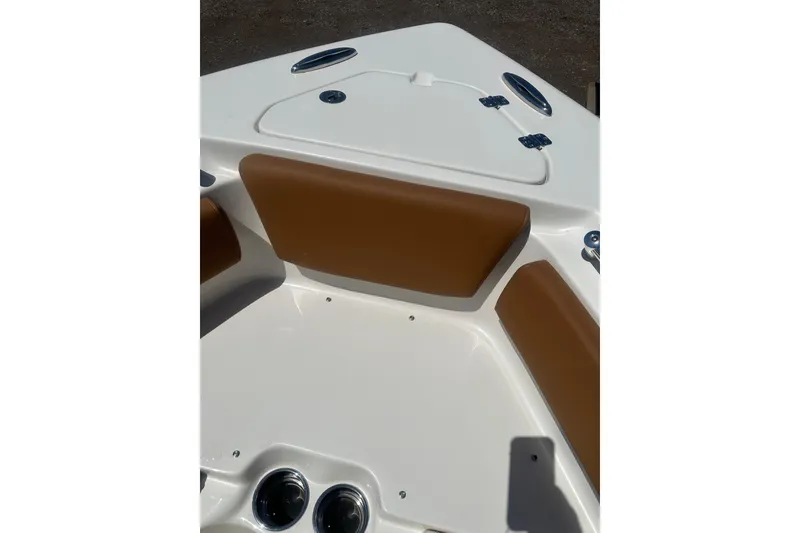 Slide: The Image of 2026 Key West 239 FS boat interior with brown cushions and storage compartment. - 20