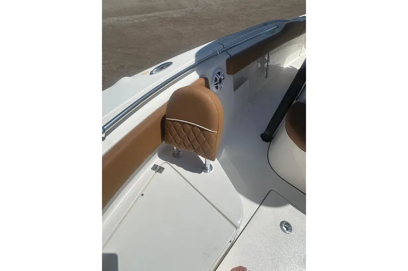 Slide: The Image of 2026 Key West 239 FS boat interior with tan seating and speaker. - 21