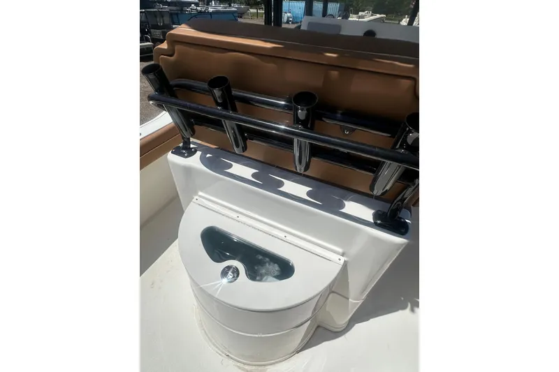 Slide: The Image of 2026 Key West 239 FS boat with integrated rod holders and storage compartment. - 25