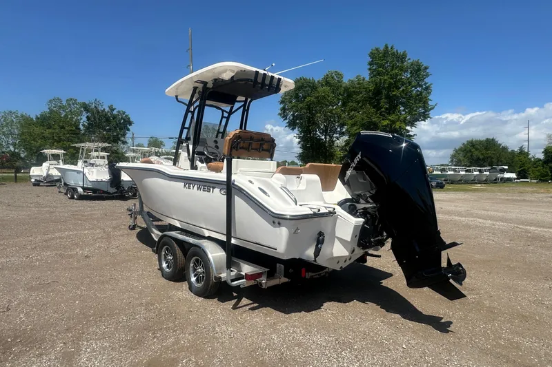 Slide: The Image of 2026 Key West 239 FS boat on trailer, parked outdoors under clear blue sky. - 3