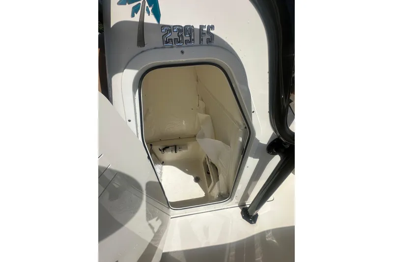 Slide: The Image of 2026 Key West 239 FS boat storage compartment with open hatch, showcasing interior space. - 31