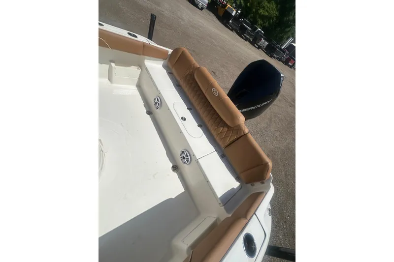 Slide: The Image of 2026 Key West 239 FS boat interior with tan seating and Mercury engine. - 38