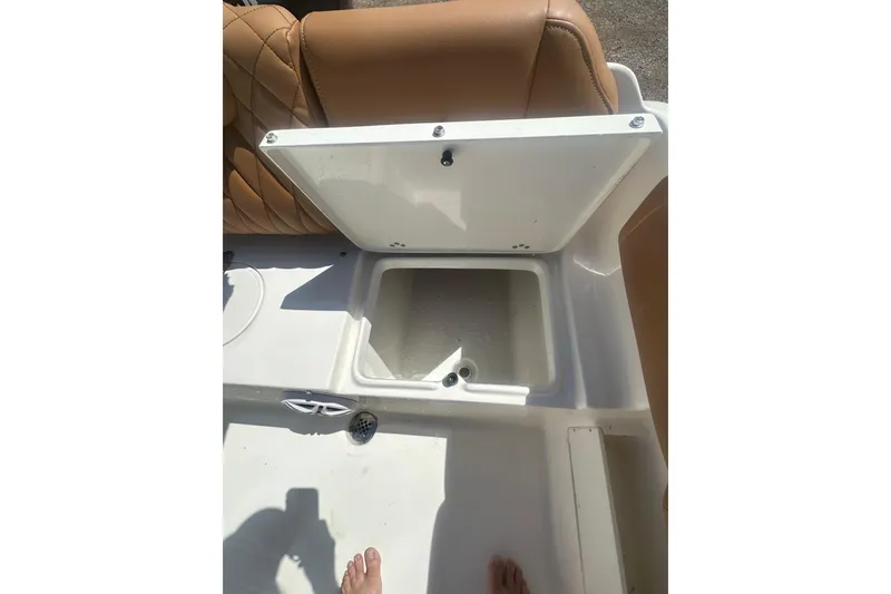 Slide: The Image of Open storage compartment on 2026 Key West 239 FS boat with tan seating. - 39