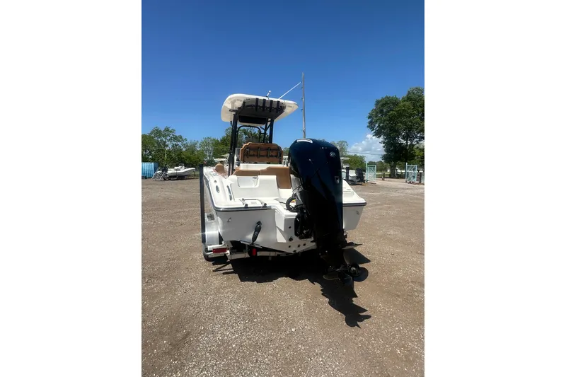 Slide: The Image of 2026 Key West 239 FS boat with outboard motor, parked on gravel under clear blue sky. - 4
