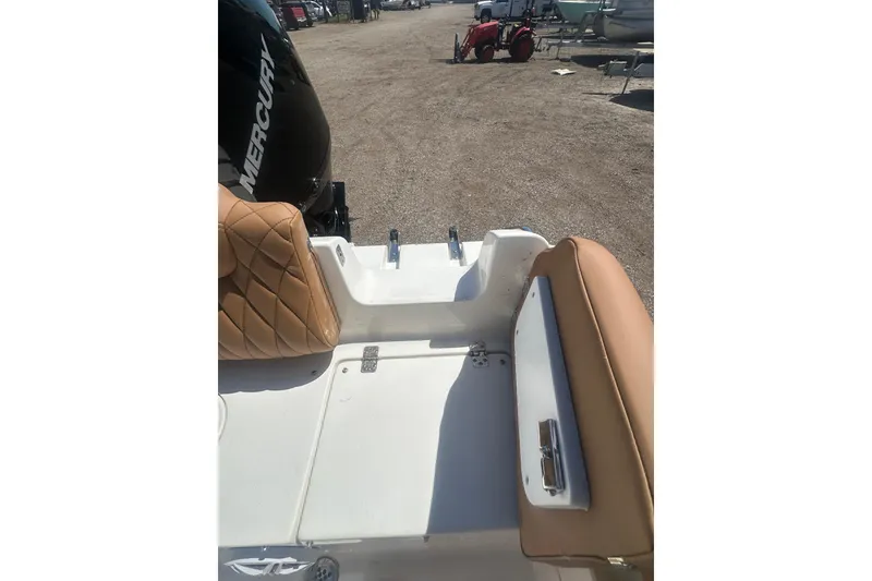 Slide: The Image of 2026 Key West 239 FS boat interior with tan seating and Mercury engine. - 40