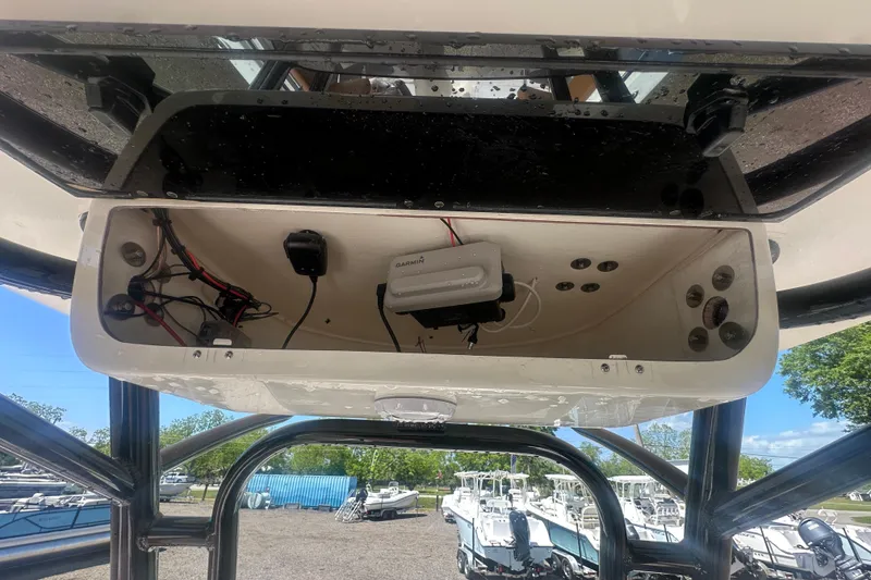 Slide: The Image of Open electronics compartment on 2026 Key West 239 FS boat, showing wiring and Garmin device. - 45