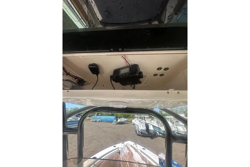 Slide: The Image of 2026 Key West 239 FS boat interior with electronic equipment and outdoor view. - 46