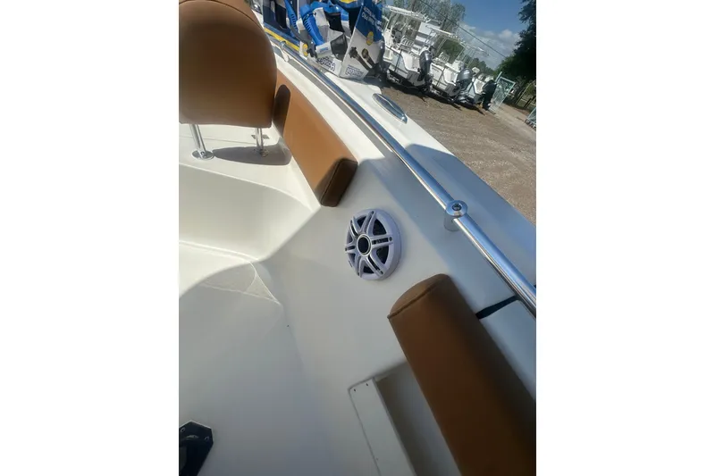 Slide: The Image of 2026 Key West 239 FS boat interior with brown seating and speaker detail. - 48