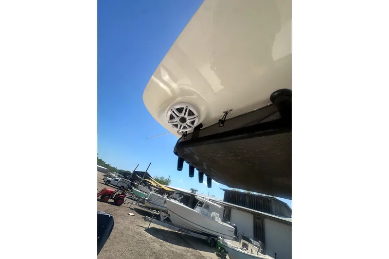 Slide: The Image of 2026 Key West 239 FS boat with visible speaker and hull detail in a marina setting. - 49