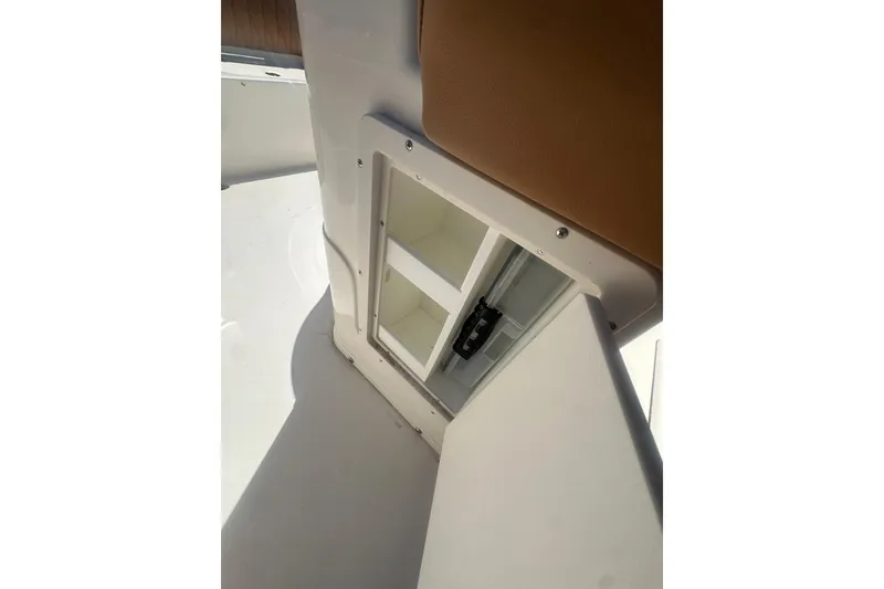 Slide: The Image of Storage compartment on a 2026 Key West 239 FS boat, featuring a sleek white interior. - 51
