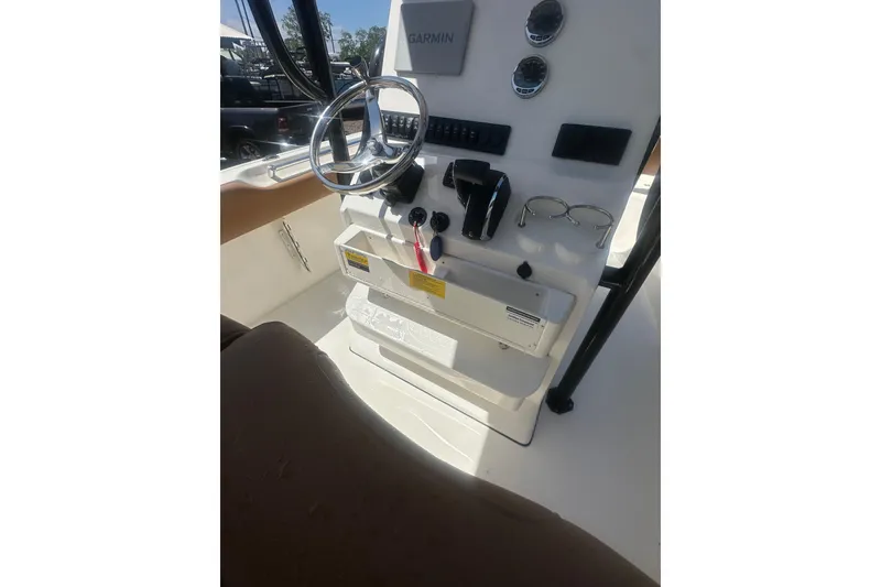 Slide: The Image of Helm of 2026 Key West 239 FS boat with steering wheel and controls. - 54