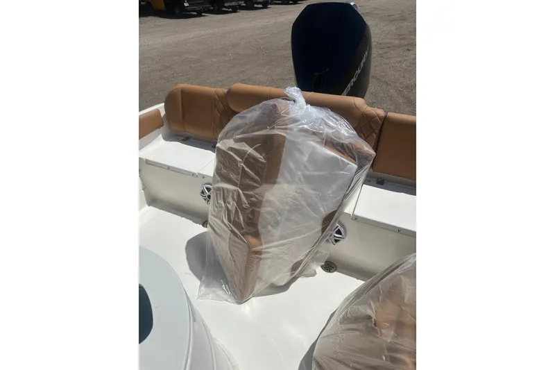 Slide: The Image of 2026 Key West 239 FS boat interior with wrapped seats and visible engine. - 59