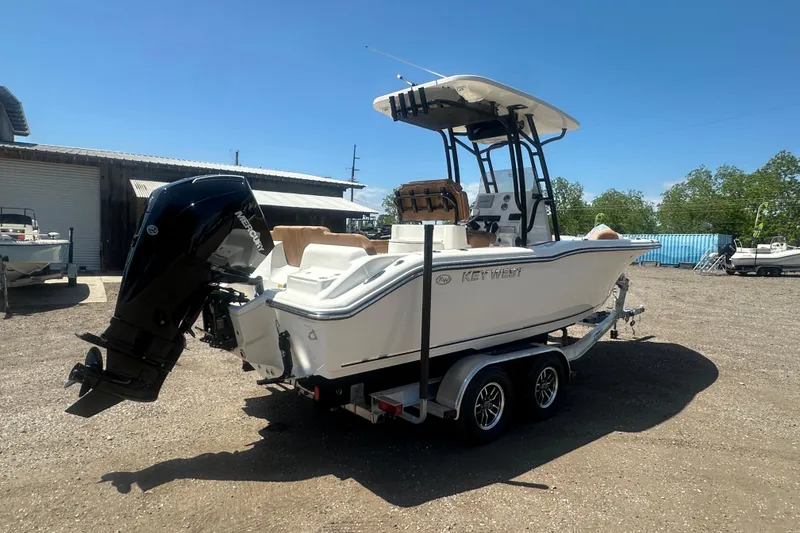 Slide: The Image of 2026 Key West 239 FS boat on trailer, parked outdoors under clear blue sky. - 6