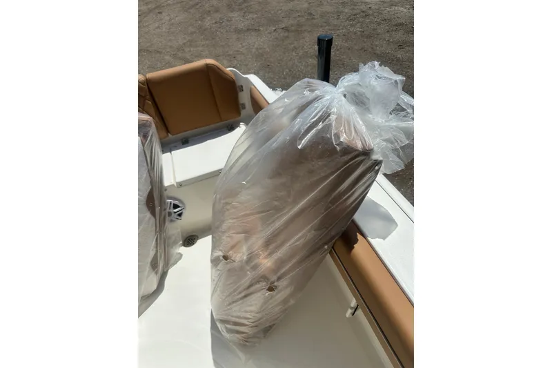 Slide: The Image of 2026 Key West 239 FS boat interior with seats wrapped in protective plastic. - 60