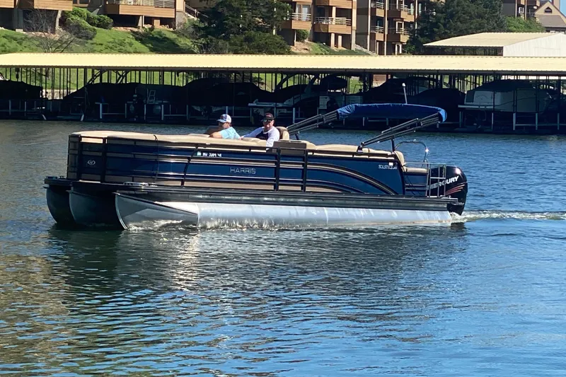 The Image of 2018 Harris Solstice 240 pontoon boat cruising on a sunny lake. - 0