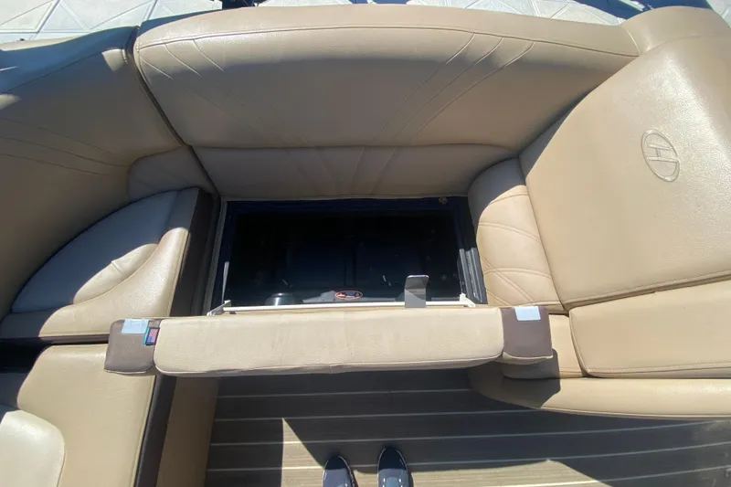 Slide: The Image of Open storage compartment on 2018 Harris Solstice 240 boat with beige seating. - 12