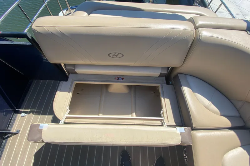 Slide: The Image of Storage compartment in 2018 Harris Solstice 240 boat with batteries and cables. - 13