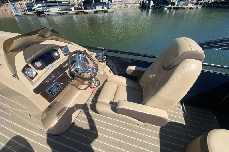 Slide: The Image of Dashboard of a 2018 Harris Solstice 240 boat with control panel and switches. - 16