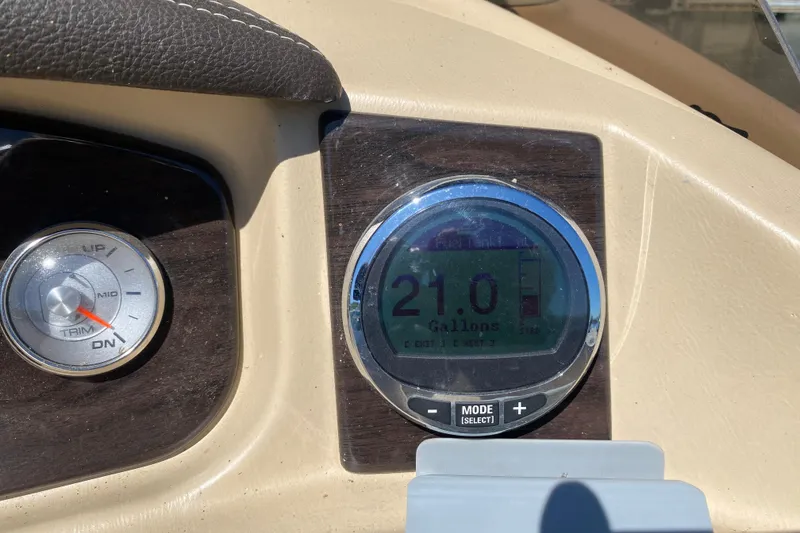 Slide: The Image of 2018 Harris Solstice 240 boat interior with beige seating and steering console. - 19