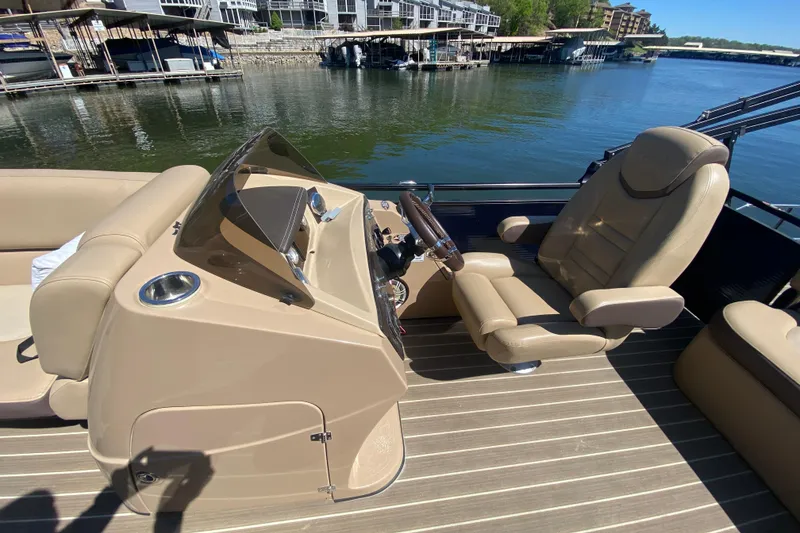 Slide: The Image of 2018 Harris Solstice 240 boat dashboard with steering wheel and control panel. - 20