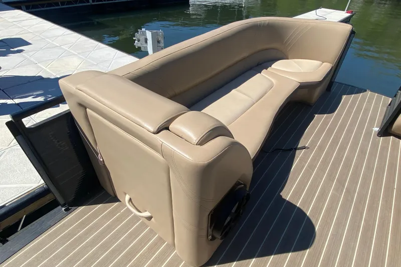 Slide: The Image of 2018 Harris Solstice 240 pontoon boat with seating and storage, docked by the water. - 23