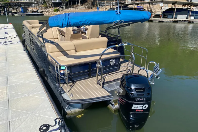 Slide: The Image of 2018 Harris Solstice 240 pontoon boat cruising on a lake with two passengers. - 28