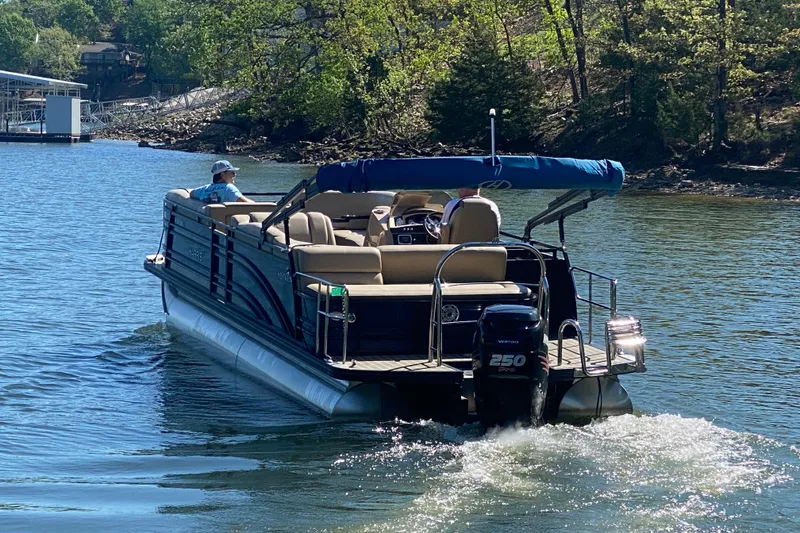 Slide: The Image of 2018 Harris Solstice 240 pontoon boat cruising on a scenic lake. - 3