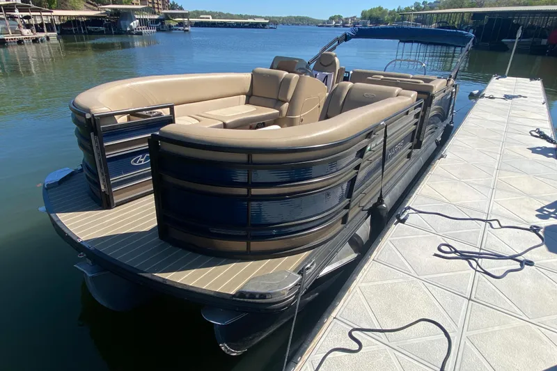 Slide: The Image of Open storage compartment on 2018 Harris Solstice 240 boat, revealing life jackets and fenders. - 5