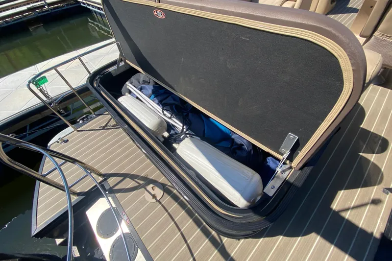 Slide: The Image of 2018 Harris Solstice 240 boat with beige leather seating on a sunny day at the dock. - 6