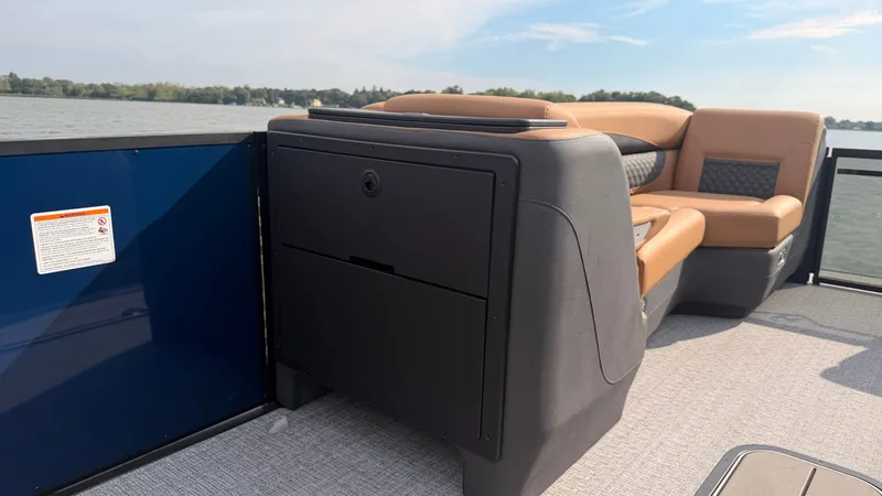 Slide: The Image of The image shows the deck of a 2027 Harris Sunliner 230 with beige seating. - 25