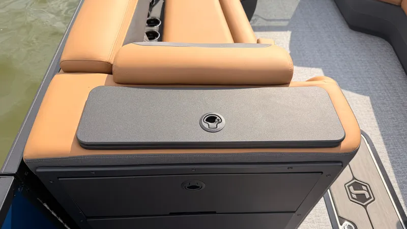 Slide: The Image of The image shows the seating area of a 2027 Harris Sunliner 230 with beige upholstery and storage. - 26