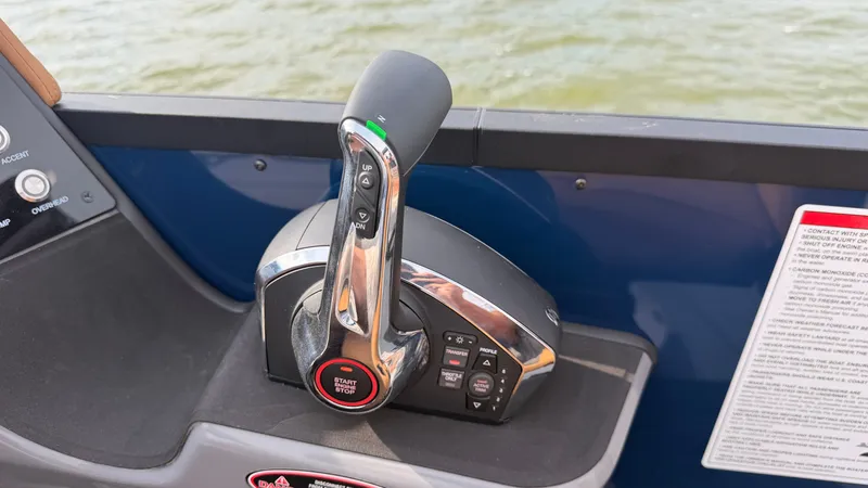 Slide: The Image of Close-up of the throttle control on a 2027 Harris Sunliner 230 boat. - 37