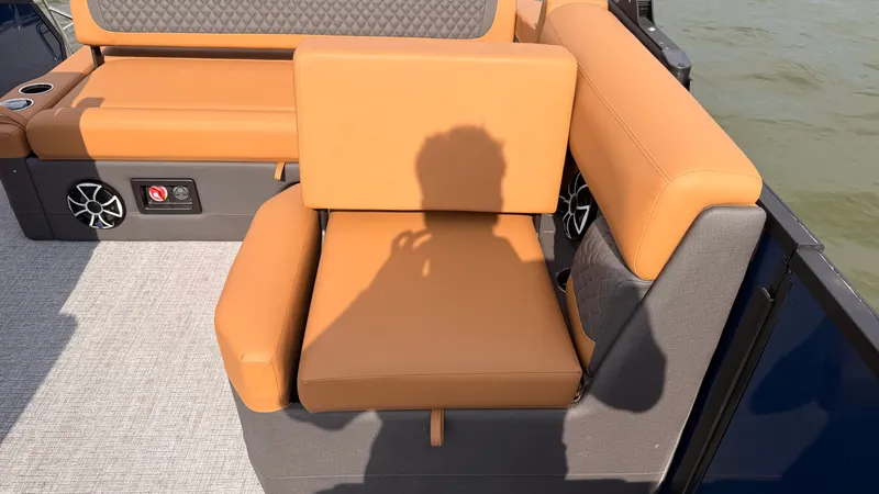 Slide: The Image of A stylish seating area with orange cushions on a boat, surrounded by water. - 42