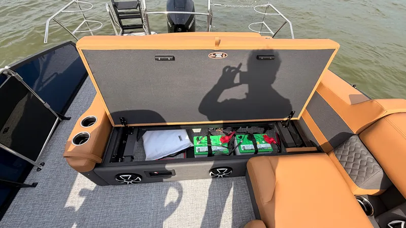 Slide: The Image of The image shows the storage area of a Harris Sunliner 230 boat with batteries and accessories. - 45