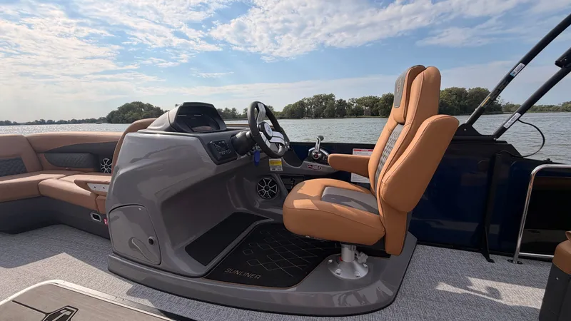Slide: The Image of The image shows the cockpit of a 2027 Harris Sunliner 230 with a comfortable helm seat. - 31