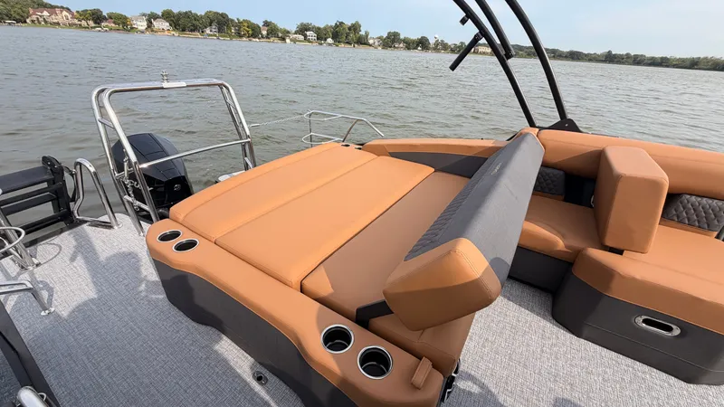 Slide: The Image of The image shows the deck of a 2027 Harris Sunliner 230 with beige upholstery and cup holders. - 46
