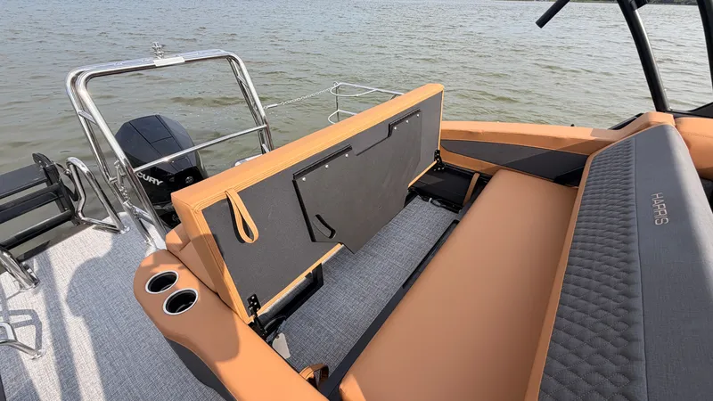 Slide: The Image of The image shows the deck of a 2027 Harris Sunliner 230 with beige upholstery and an outboard motor. - 48