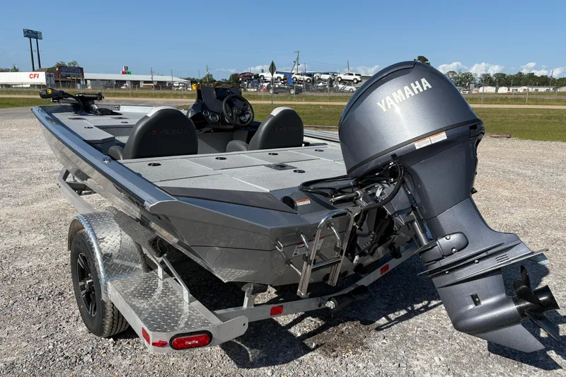 Slide: The Image of 2026 Vexus AVX181 boat with Yamaha motor on trailer, parked outdoors. - 4