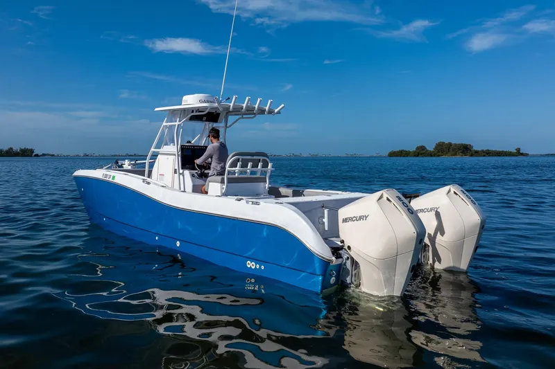 The Image of 1998 World Cat 266 SF boat with twin Mercury engines on calm water. - 0