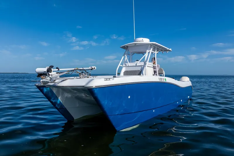 Slide: The Image of 1998 World Cat 266 SF boat on calm blue water under clear sky. - 10