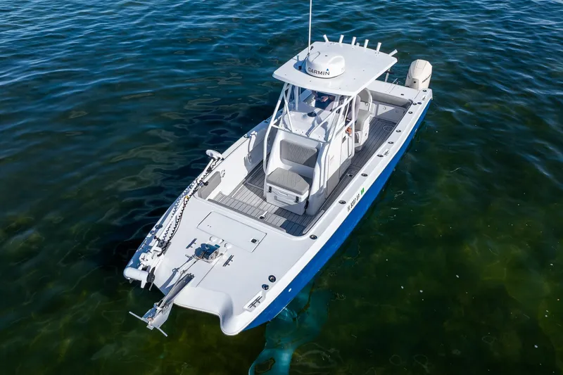 Slide: The Image of 1998 World Cat 266 SF boat on calm water, aerial view. - 12