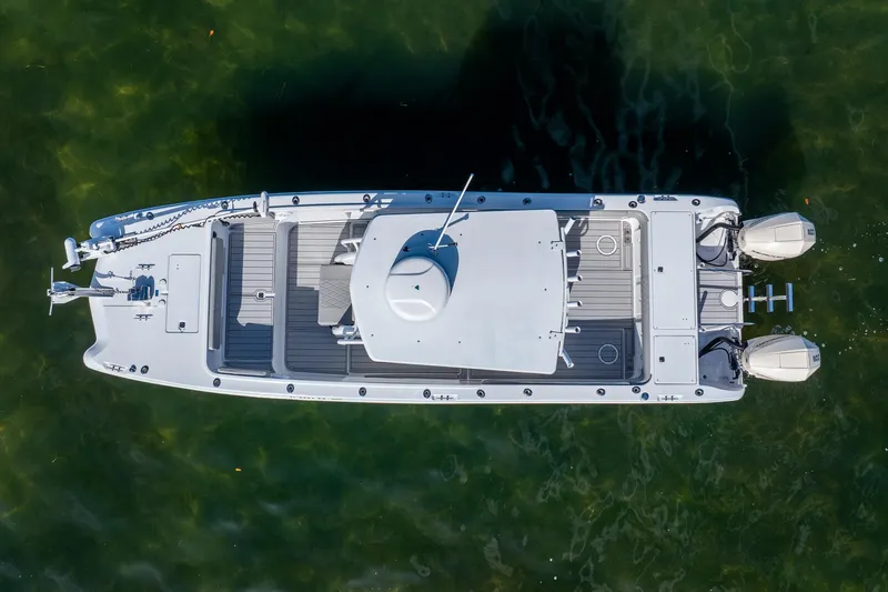Slide: The Image of Overhead view of a 1998 World Cat 266 SF boat on clear water. - 13